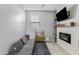 Bonus room featuring a modern electric fireplace, built-in shelves, large flatscreen TV, and comfortable seating at 4087 W Coneflower Ln, San Tan Valley, AZ 85144