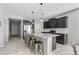 Open-concept kitchen boasts a large island, stainless steel appliances, and sleek gray cabinets at 4087 W Coneflower Ln, San Tan Valley, AZ 85144