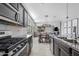 Gourmet kitchen with stainless steel appliances, granite countertops, and open layout to living areas at 4087 W Coneflower Ln, San Tan Valley, AZ 85144