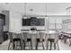 Modern kitchen featuring a large island, stainless steel appliances, and dark cabinetry at 4087 W Coneflower Ln, San Tan Valley, AZ 85144