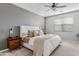 Serene main bedroom featuring a large bed, stylish nightstands, and a ceiling fan at 4087 W Coneflower Ln, San Tan Valley, AZ 85144