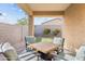 Inviting covered patio with modern furniture, pavers, string lights, and a well-maintained backyard at 4087 W Coneflower Ln, San Tan Valley, AZ 85144