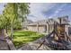 Spacious backyard featuring lush green grass, a playground set, and a covered patio for outdoor enjoyment at 4215 S Marisol Ln, Gilbert, AZ 85297