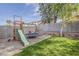 Well-maintained backyard showcasing lush grass, a playground set, and a trampoline for recreational activities at 4215 S Marisol Ln, Gilbert, AZ 85297