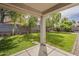 Expansive backyard featuring a lush green lawn, mature trees, and a covered patio area for outdoor enjoyment at 4215 S Marisol Ln, Gilbert, AZ 85297
