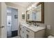 Elegant bathroom featuring double sinks, marble countertop, and modern black fixtures at 4215 S Marisol Ln, Gilbert, AZ 85297