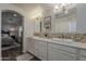Bright bathroom with dual sinks, mosaic backsplash, and access to an adjacent bedroom at 4215 S Marisol Ln, Gilbert, AZ 85297