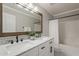 Bright bathroom featuring double sinks, marble countertop, and framed mirror at 4215 S Marisol Ln, Gilbert, AZ 85297