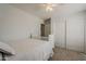 Serene bedroom showcasing a white bed, closet, and neutral carpet at 4215 S Marisol Ln, Gilbert, AZ 85297