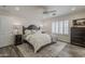 A serene bedroom features a plush bed, wood floors, and a large window with plantation shutters at 4215 S Marisol Ln, Gilbert, AZ 85297