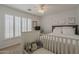 Bright bedroom with a ceiling fan, shutters, and a bed, creating a serene atmosphere at 4215 S Marisol Ln, Gilbert, AZ 85297