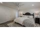 A light and bright bedroom features a large bed, wood floors, and crisp white walls at 4215 S Marisol Ln, Gilbert, AZ 85297