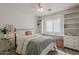 Charming bedroom featuring a queen-sized bed, built-in shelves, and soft natural light at 4215 S Marisol Ln, Gilbert, AZ 85297