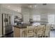 Modern kitchen with stainless steel appliances, grey countertop island and white cabinets at 4215 S Marisol Ln, Gilbert, AZ 85297