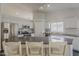 Modern kitchen with stainless steel appliances, grey countertop island and white cabinets at 4215 S Marisol Ln, Gilbert, AZ 85297
