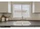 Bright kitchen features a stainless steel faucet, white cabinets, and a subway tile backsplash at 4215 S Marisol Ln, Gilbert, AZ 85297