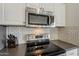 Modern kitchen with stainless steel appliances, including a Samsung microwave and electric cooktop at 4215 S Marisol Ln, Gilbert, AZ 85297