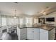 Kitchen island with white cabinets and a large dining room area at 4215 S Marisol Ln, Gilbert, AZ 85297