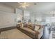 Spacious living room with hardwood floors, a large sofa, and an open floor plan at 4215 S Marisol Ln, Gilbert, AZ 85297
