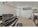 Spacious living room featuring a piano, neutral carpeting, and lots of natural light at 4215 S Marisol Ln, Gilbert, AZ 85297