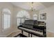 Close up of grand piano in a room with ample lighting from the large arched window at 4215 S Marisol Ln, Gilbert, AZ 85297