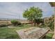 Beautiful backyard with a modern fire pit, artificial turf, and comfortable lounge chairs at 4497 E Ficus Way, Gilbert, AZ 85298