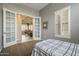 Sunlit bedroom with stylish french doors, neutral colors, plantation shutters, and a ceiling fan at 4497 E Ficus Way, Gilbert, AZ 85298
