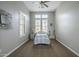 Comfortable bedroom with neutral tones, plantation shutters, a ceiling fan, and ample natural light at 4497 E Ficus Way, Gilbert, AZ 85298