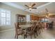 Dining area with an expansive dining table, blending classic charm with modern kitchen access at 4497 E Ficus Way, Gilbert, AZ 85298