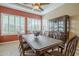 Dining room with a large table, shuttered windows, and a cabinet for elegant, comfortable dining at 4497 E Ficus Way, Gilbert, AZ 85298