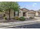 Well-maintained one-story house enhanced by verdant landscaping and a paved driveway to the attached three-car garage at 4497 E Ficus Way, Gilbert, AZ 85298