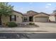 Attractive single-level home showcasing a well-kept front yard and a driveway leading to a convenient three-car garage at 4497 E Ficus Way, Gilbert, AZ 85298
