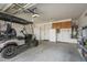 Spacious garage featuring a golf cart, ample storage, and a clean, well-maintained floor at 4497 E Ficus Way, Gilbert, AZ 85298