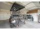 Attached garage with storage, and a parked golf cart at 4497 E Ficus Way, Gilbert, AZ 85298