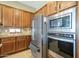 Kitchen with stainless refrigerator, microwave, oven, and custom wood cabinetry at 4497 E Ficus Way, Gilbert, AZ 85298