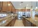 Gourmet kitchen featuring granite countertops, a large island, and stainless steel appliances at 4497 E Ficus Way, Gilbert, AZ 85298