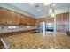 Spacious kitchen with granite counters, stainless appliances, and wooden cabinetry at 4497 E Ficus Way, Gilbert, AZ 85298