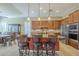 Kitchen island with granite countertops, stainless steel appliances, and wood cabinets at 4497 E Ficus Way, Gilbert, AZ 85298