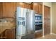 Kitchen featuring stainless steel refrigerator, oven, microwave, and wood cabinets at 4497 E Ficus Way, Gilbert, AZ 85298