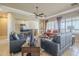 Open-concept living room showcases a sectional sofa, ceiling fan, and a view of the dining area at 4497 E Ficus Way, Gilbert, AZ 85298
