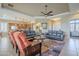 Inviting living room featuring dual sofas, ceiling fan, and an open floor plan to the kitchen at 4497 E Ficus Way, Gilbert, AZ 85298