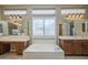 Bright main bathroom featuring a garden tub, double vanities, and plentiful lighting from a large window at 4497 E Ficus Way, Gilbert, AZ 85298