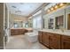 Bright main bathroom showcasing a garden tub, double sink vanities, and plentiful light from large windows at 4497 E Ficus Way, Gilbert, AZ 85298