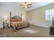 The primary bedroom showcases a ceiling fan, an accent wall, and a window dressed with plantation shutters at 4497 E Ficus Way, Gilbert, AZ 85298