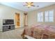 Spacious main bedroom features a ceiling fan, plantation shutters, and an ensuite bathroom at 4497 E Ficus Way, Gilbert, AZ 85298