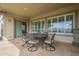 Covered patio featuring an outdoor dining set with well-maintained tile flooring and large windows at 4497 E Ficus Way, Gilbert, AZ 85298