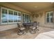 Covered patio with outdoor seating, large windows and textured stucco walls at 4497 E Ficus Way, Gilbert, AZ 85298