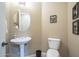 Cozy powder room features a pedestal sink and a toilet at 4497 E Ficus Way, Gilbert, AZ 85298