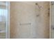Well-lit walk-in shower featuring tile surround and grab bar for accessibility at 4497 E Ficus Way, Gilbert, AZ 85298