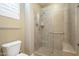 Walk-in shower features a glass door, tiled walls, and a built-in seat at 4497 E Ficus Way, Gilbert, AZ 85298